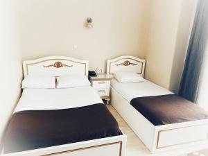 two beds sitting next to each other in a room at Hotel Seref in Yalova +15 photos