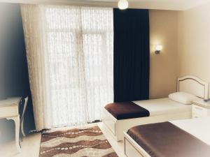 a bedroom with two beds and a window at Seref Hotel in Yalova