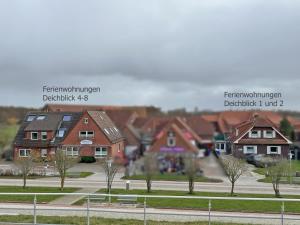 a group of houses in a residential neighborhood at Deichblick 5 in Norddeich- Urlaub und Meerblick in Norden