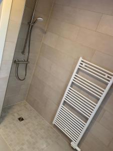 a shower with a white grate in a bathroom at Landblick 2 in Norddeich