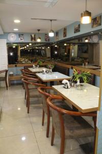 a dining room with tables and chairs in a restaurant at Hotel Falcon in Istanbul