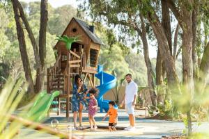 a family standing in front of a playground at Pullman Mazagan Royal Golf & Spa in El Jadida