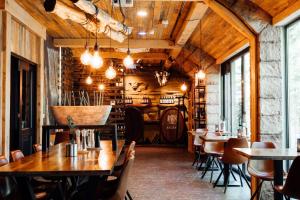a restaurant with wooden ceilings and tables and chairs at Boutique Hotel, Restaurant & Wellness Westerburcht in Westerbork