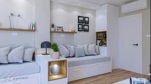 a living room with two beds and a door at Frosty Peaks Apartment in Kopaonik