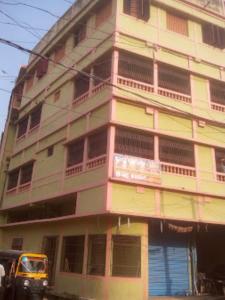 a yellow truck parked in front of a building at Indra Bhawan Lodge, Cuttack in Cuttack