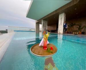 a drink on a tray in a swimming pool at Grand River View Hotel - Rajshahi in Rājshāhi