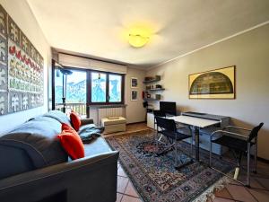 a living room with a couch and a table at Hostdomus -Pastore Apartment in Sestriere