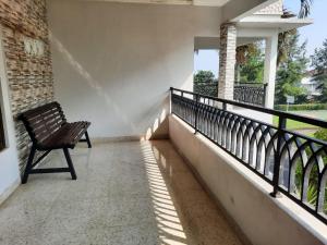 a bench sitting on the balcony of a house at Villa Bukit Nirwana in Bogor