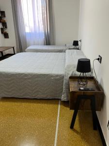 a bedroom with a bed and a table with a lamp at Gaslini Sea House in Genoa