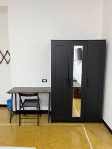 a black cabinet in a room with a table at Gaslini Sea House in Genoa +19 photos