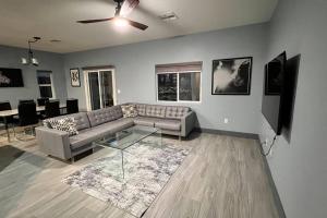 a living room with a couch and a table at Family Friendly Contemporary House with Pool in Las Vegas