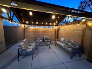 a patio with couches and lights on a brick wall at Family Friendly Contemporary House with Pool in Las Vegas