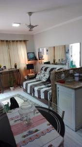 - un salon avec deux lits et une table dans l'établissement Casa do Braga, à Cabo Frio