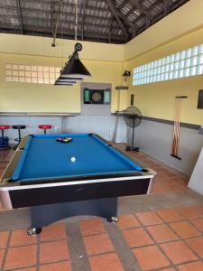 a pool table in the middle of a room at Bali Residence in Mae Pim