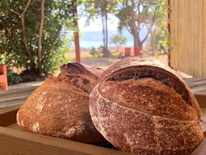 two loaves of bread sitting on a wooden table at Bed & Bread in Chorazim