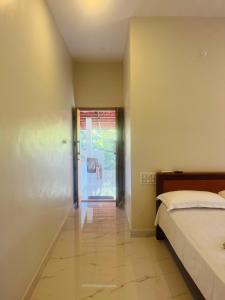 a bedroom with a bed and a sliding glass door at Munroe Meadows home in Munroe Island