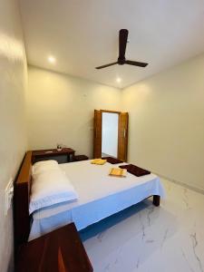 a bedroom with a bed with a ceiling fan at Munroe Meadows home in Munroe Island