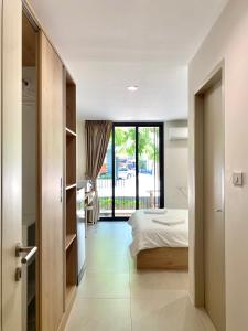 a bedroom with a bed and a view of a balcony at POP Heritage Residence in Bangkok