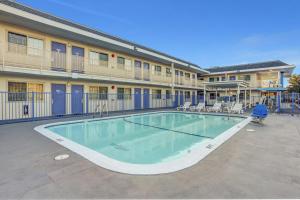 a swimming pool in front of a building with a hotel at Motel 6-Napa, CA in Napa