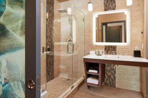 a bathroom with a sink and a shower with a mirror at The Westin Desaru Coast Resort in Desaru