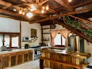 a large kitchen with wooden cabinets and a counter top at Casa El Alux Campestre in Macario Gomez