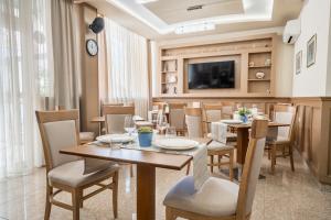 A television and/or entertainment centre at AquaSun Family Hotel