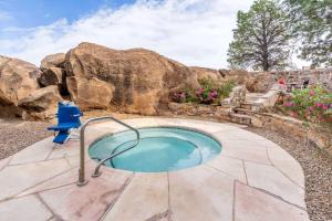 a hot tub in a backyard with rocks at La Quinta by Wyndham Santa Rosa in Santa Rosa