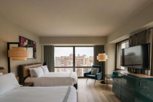 芝加哥的住宿－Thompson Chicago, by Hyatt，酒店客房设有两张床和一台平面电视。