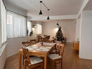 a dining room with a table and a christmas tree at Villa NOVA Cozy and Modern -5 min from center in Bran