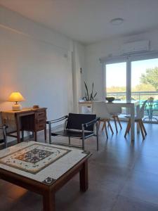a living room with a table and chairs at Departamento Margaritas in Santa Rosa