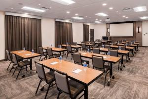 a conference room with tables and chairs and a screen at Hyatt Place Fort Worth-Alliance Town Center in Fort Worth
