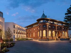 a large brick building with a pointed roof at Mercure Conacul Cozieni in Bucharest