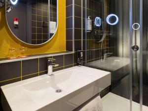 a bathroom with a white sink and a shower at ibis Kyiv Beresteiska in Kyiv