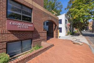 a building with a sign that reads georgetown suites at Georgetown Residences by LuxUrban in Washington, D.C.