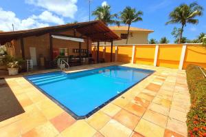 a swimming pool in the backyard of a house at Aconchego do Caranã in Salinópolis