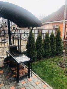 a black umbrella on a table in a yard at Julia in Uman