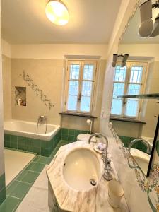 a bathroom with a large sink and a tub and a bath tub at Villa Favilli in Pisa