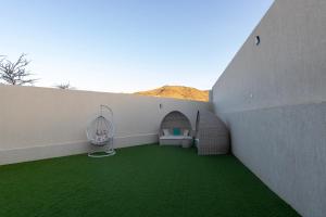 a room with green grass on the side of a building at Arayik Resort in Taif
