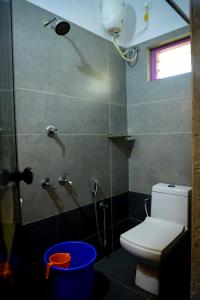 a bathroom with a toilet and a shower with a window at Marari Anns Casa Beach Homestay in Mararikulam