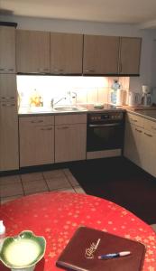 a kitchen with a table with a pen on it at Waldesruh Strausberg in Strausberg +24 photos