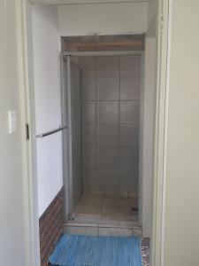 an open door to a shower in a room at Jean Michael Self-catering apartment for stay overs in Pretoria