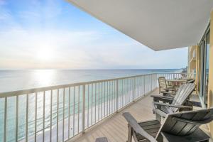 a balcony with chairs and a view of the ocean at Majestic Beach Towers 2-1701 in Panama City Beach