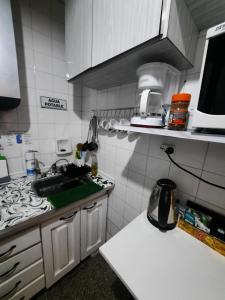 a small kitchen with a sink and a stove at Vivi la mejor experiencia en el corazon de BA !!!! in Buenos Aires