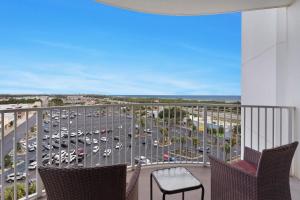 a balcony with chairs and a view of a parking lot at Palms Resort #1814 Jr. 2BR in Destin