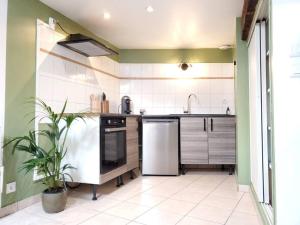 a kitchen with a sink and a refrigerator at Dupplex, centre ville in Blois +8 photos