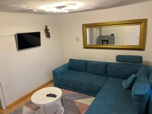 sala de estar con sofá azul y espejo en Landhaus inklusive Parkplatz, en Schotten