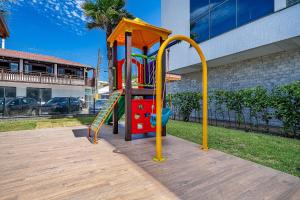 a playground with a slide in a yard at Edifício Solar do Atlântico Beira Mar de Bombas in Bombinhas