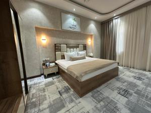a bedroom with a large bed in a room at Green Park Hotel in Tashkent