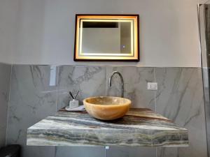 a bathroom with a bowl sink and a mirror at Vitozzi Suite in Orvieto +10 photos