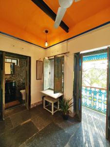 a bathroom with a table and a window and a sink at Barefoot Boutique Hotel Udaipur in Udaipur